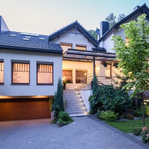 Big detached house in the evening with lights on